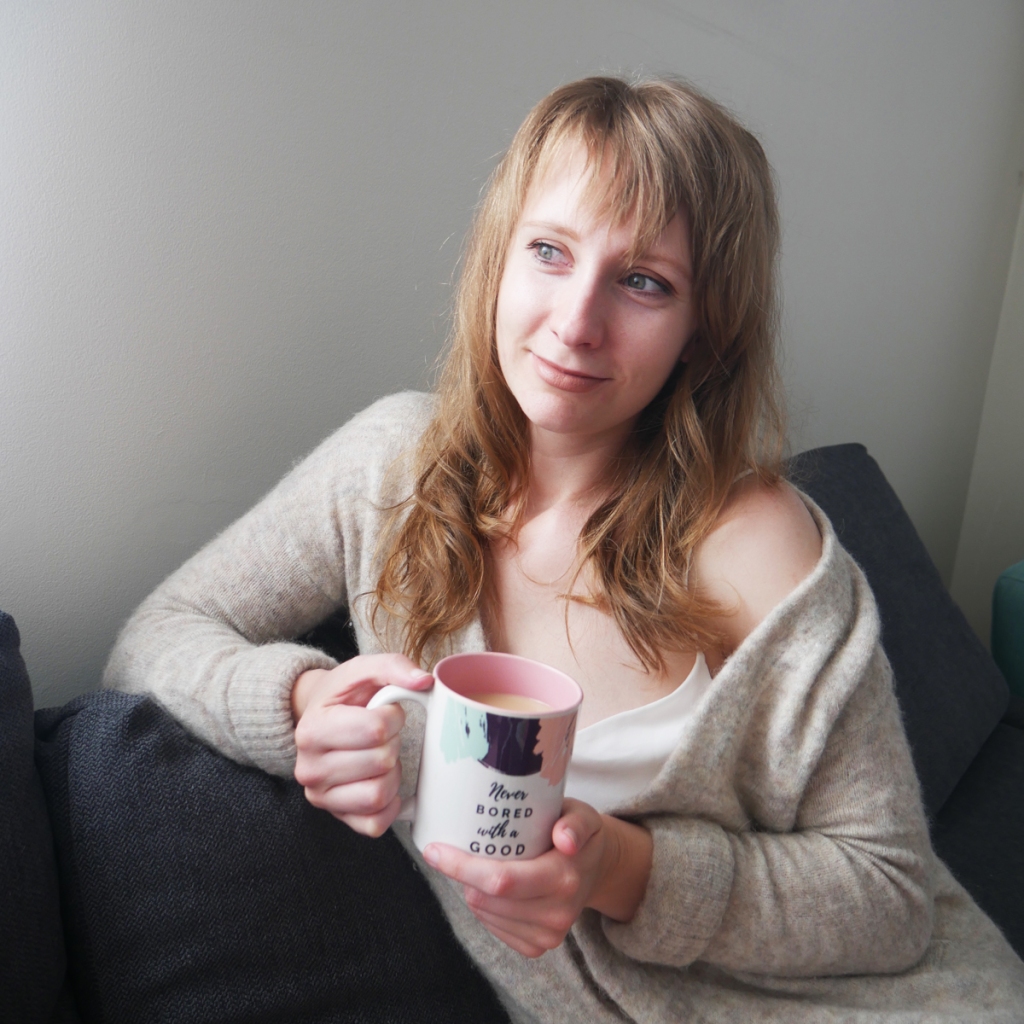 woman sitting on lounge with cup of tea